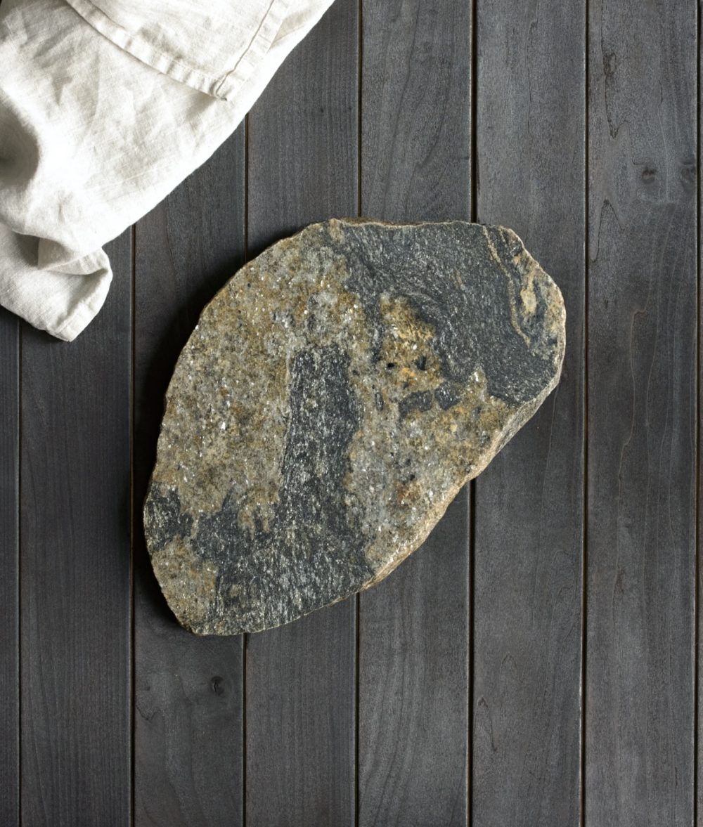 metamorphic stone charcuterie boards with gray, black and yellow colors with white napkin on top of a wooden background