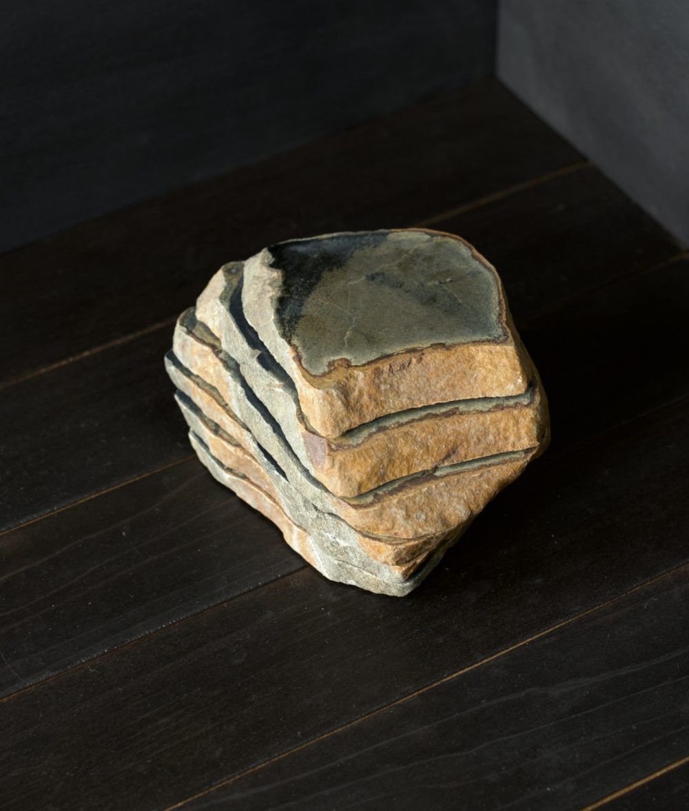 set of four quartz stone coasters on top of a wooden background