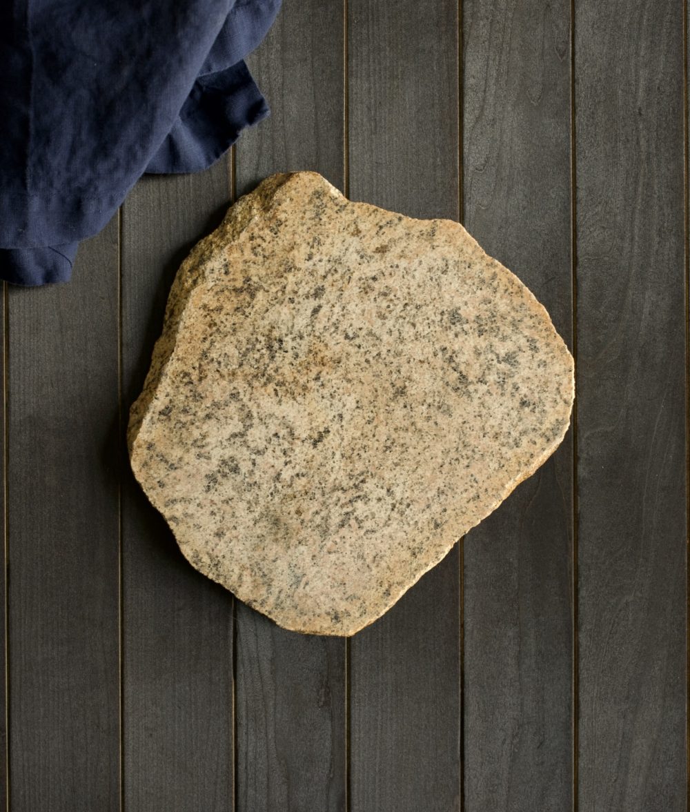 metamorphic stone charcuterie boards with gray and yellow colors with blue napkin on top of a wooden background